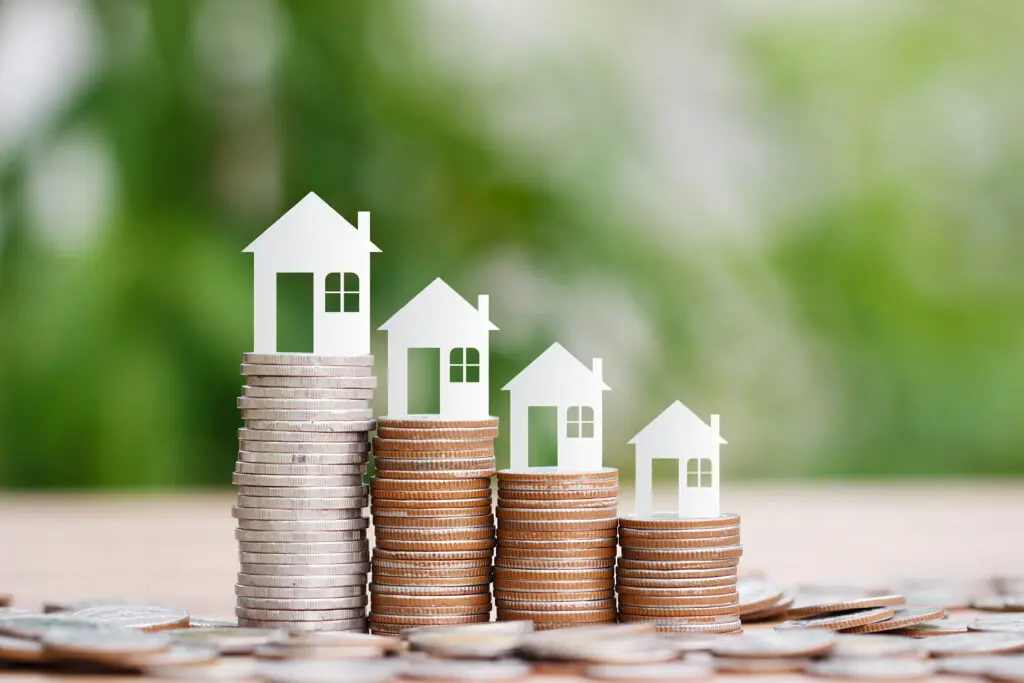 A pile of coins with houses on top