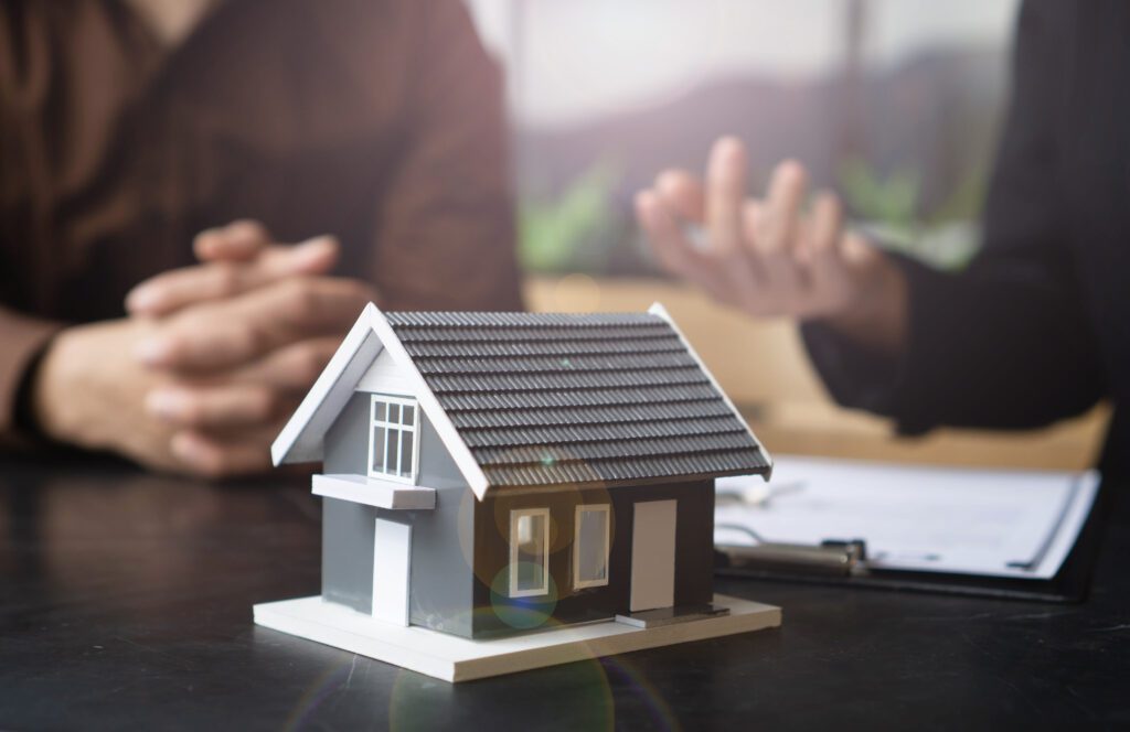 A small model house sitting on top of a table.