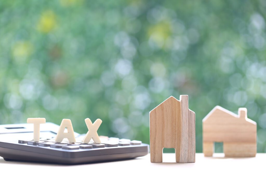 A calculator and some wooden houses on top of a table.